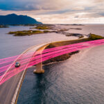 Bridge going over a body of water with pink beams