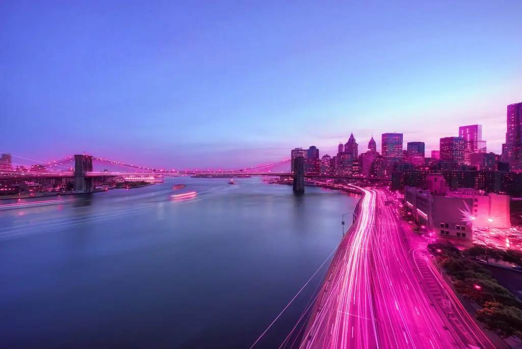 City overlooking the ocean surrounded by a pink beam