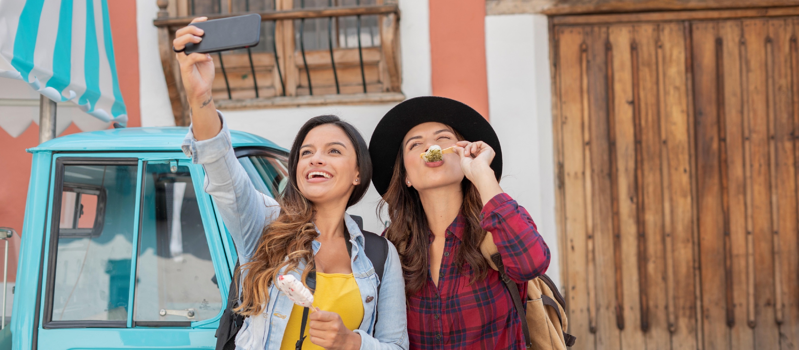 Two young women smiling and taking a selfie together.